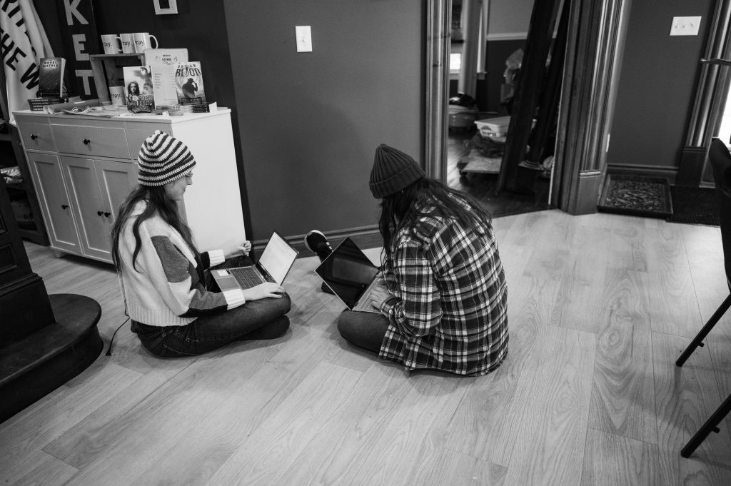 Sarah and Jenna writing on the floor at The Company